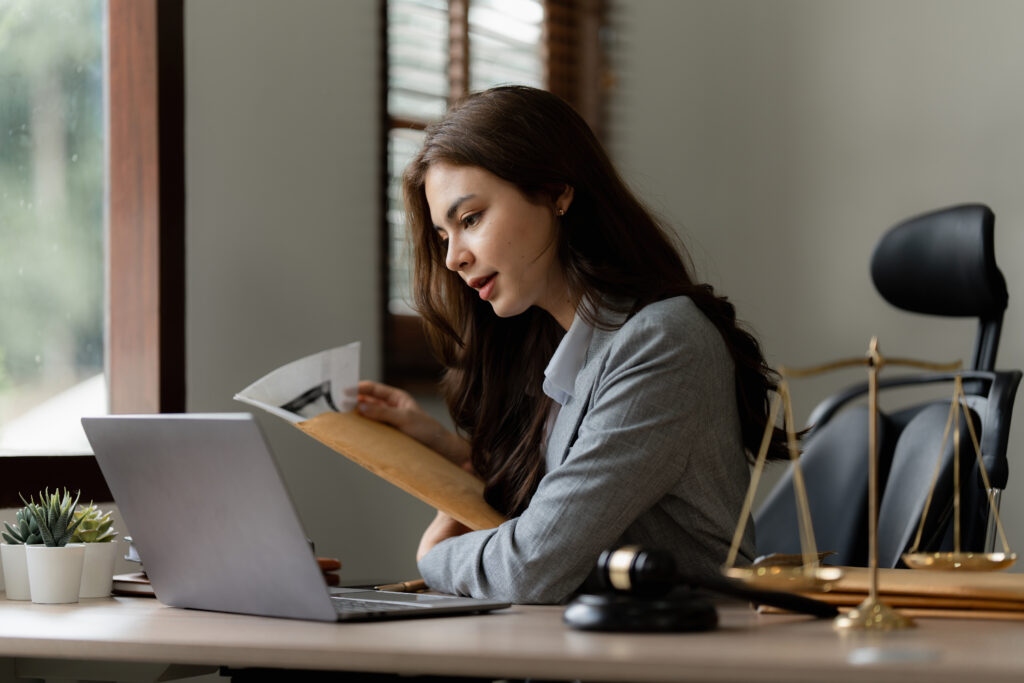 A CPA in a dress shirt with long hair utilizing trust accounting basics to conduct an accurate and comprehensive trust accounting.