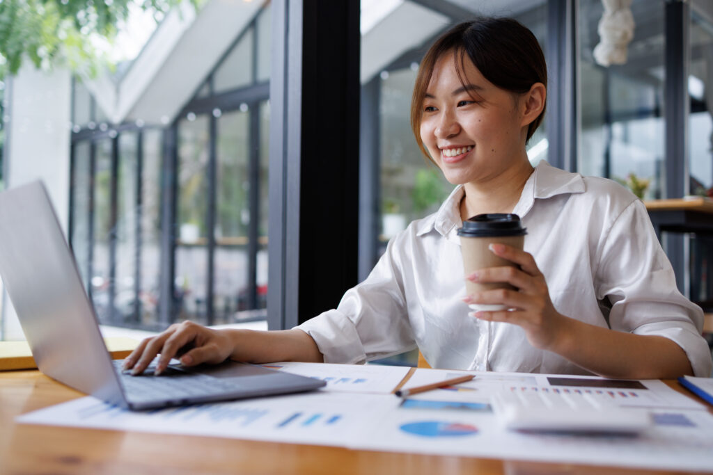 A trust accountant smiling because she knows that she can help a beneficiary identify a misappropriation of trust funds.