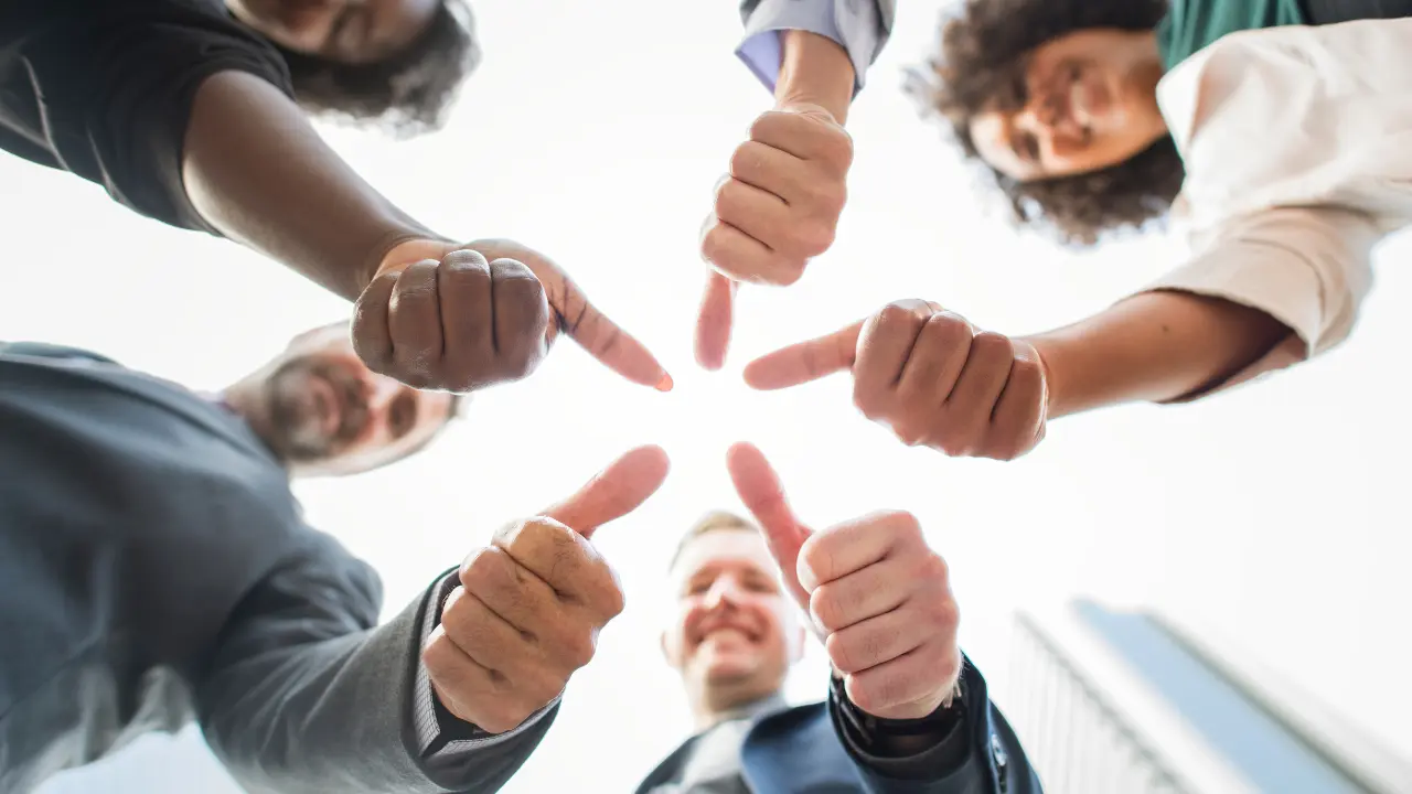 Employee celebrating giving thumbs up - employee recognition