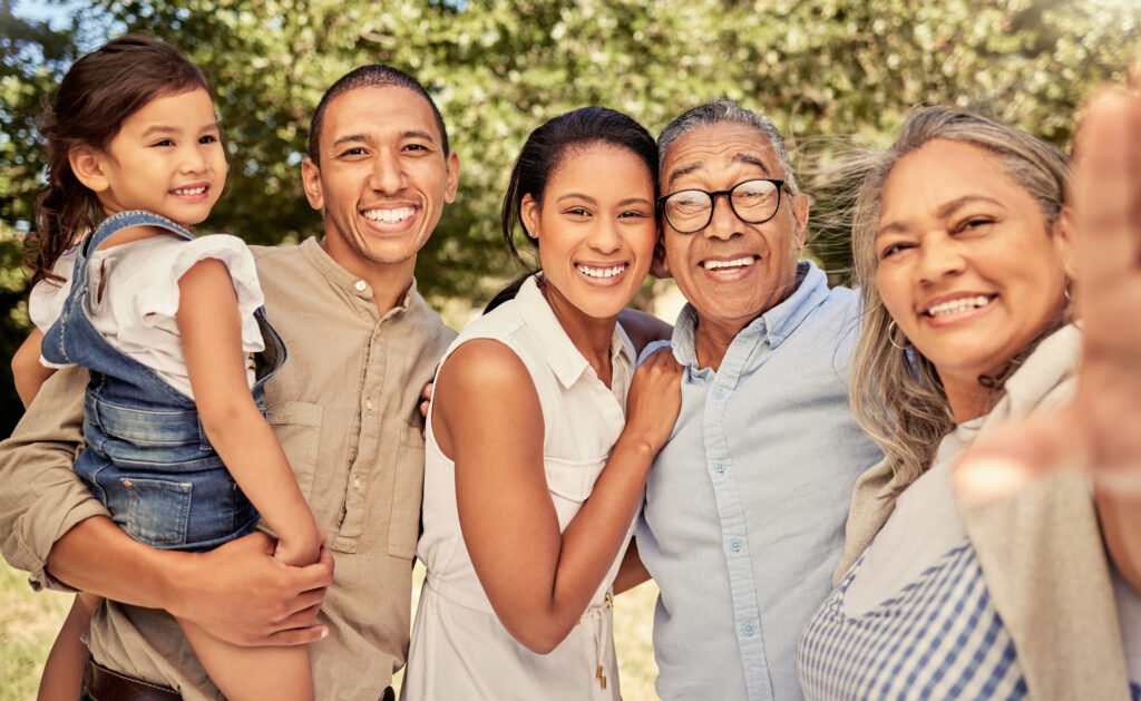Multiple generations of a family, smiling and proud because their loved one decided to combine estate planning and charitable giving to leave a lasting legacy.