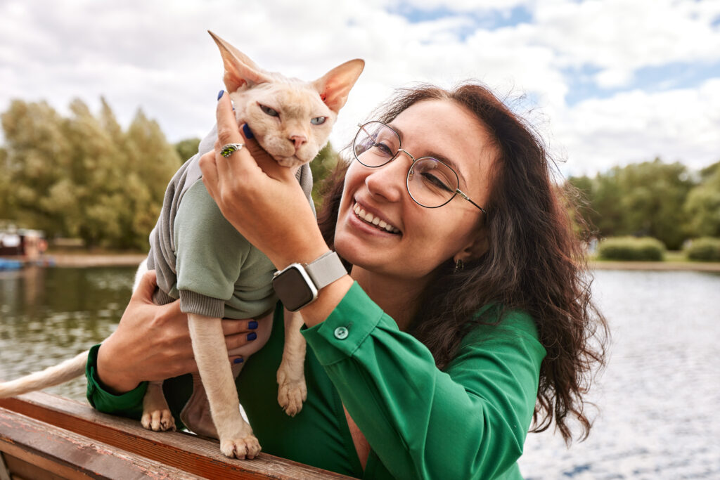 A woman with her pet, smiling because she knows that they will be taken care of with a pet trust!