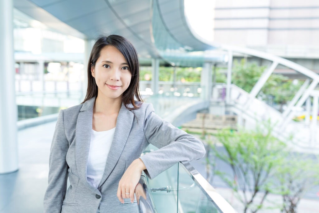 Confident businesswoman at modern office complex