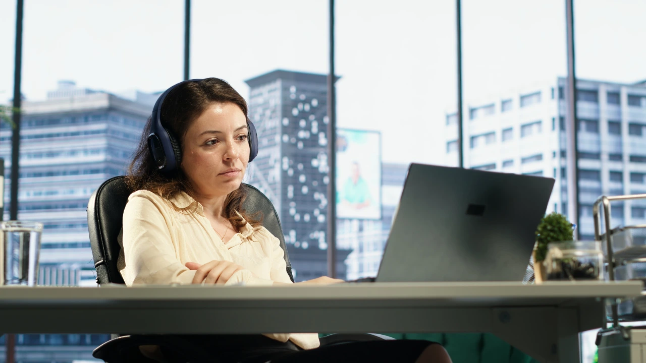 Virtual Assistant looking at her computer, without a Development Plan or career path