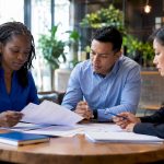 Diverse professionals discussing employment dispute documents