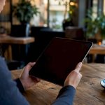 Hands holding tablet during accommodation request
