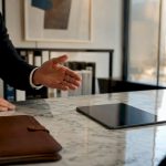 Lawyer’s hand pointing tablet in office